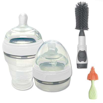 Two baby bottles (one collapsed and one expanded), a soap dispensing brush, and a nipple brush