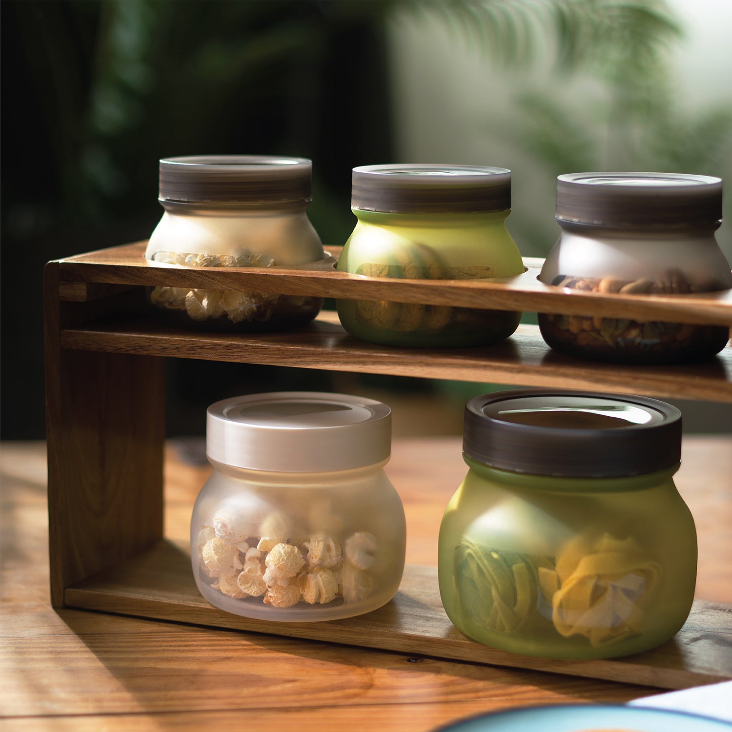 Silicone jars filled with various content stacked on a shelf