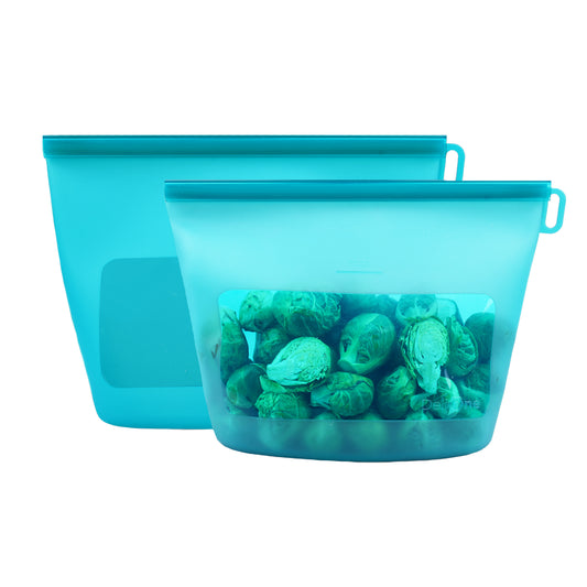 Two silicone food storage bags filled with Brussels sprouts