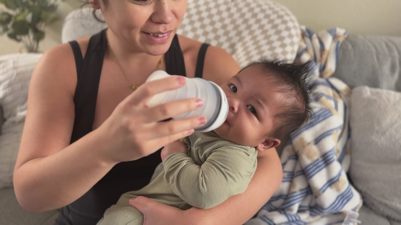 Video of a mom and baby showcasing a collapsible baby bottle