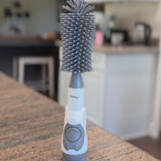 Product overview of a soap dispensing bottle brush
